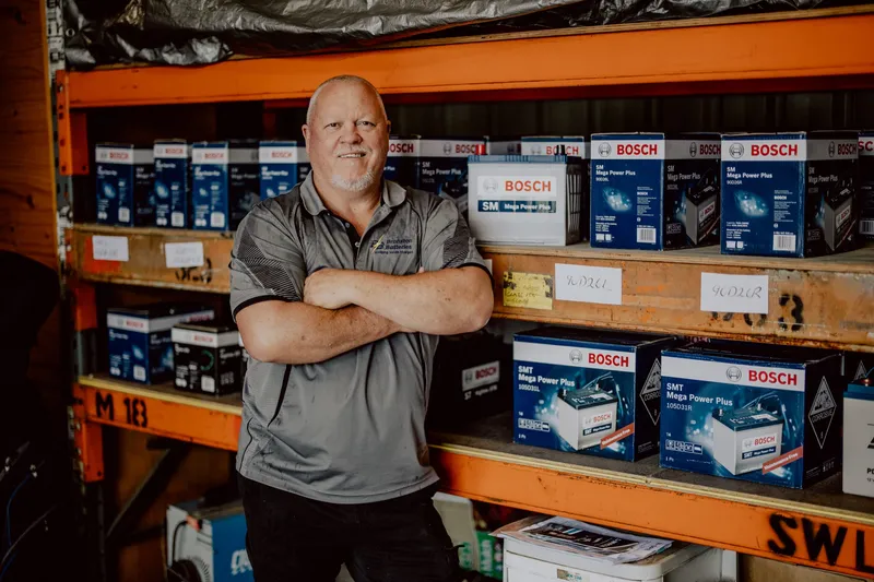 The owner of Branxton Batteries in his parts store